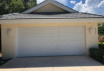 Broken torsion garage door spring before replacement in The Woodlands, TX home